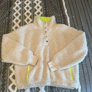 Barely worn 3/4 pullover. Cream teddy material with neon green details